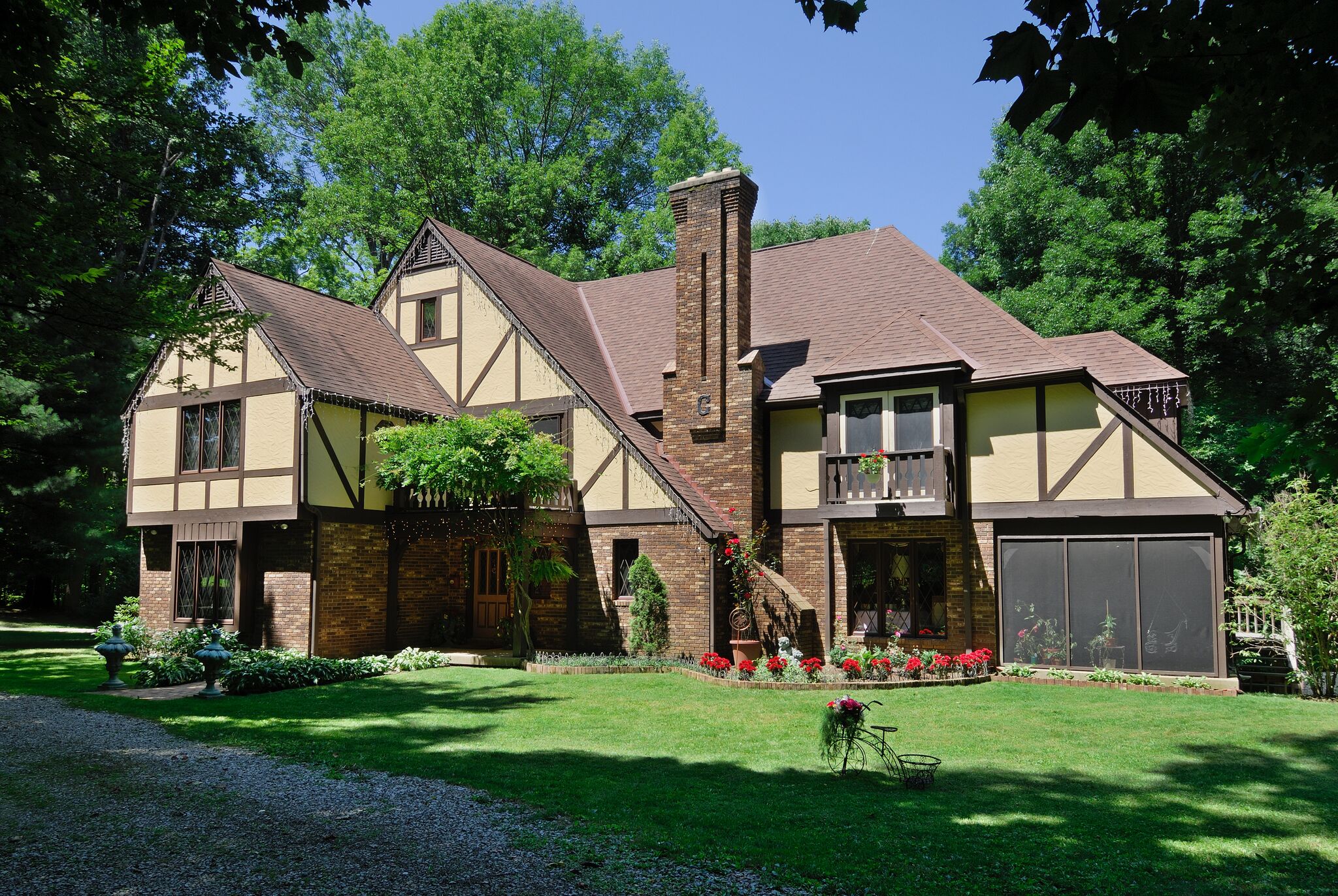 front of english tudor manor on sunny day